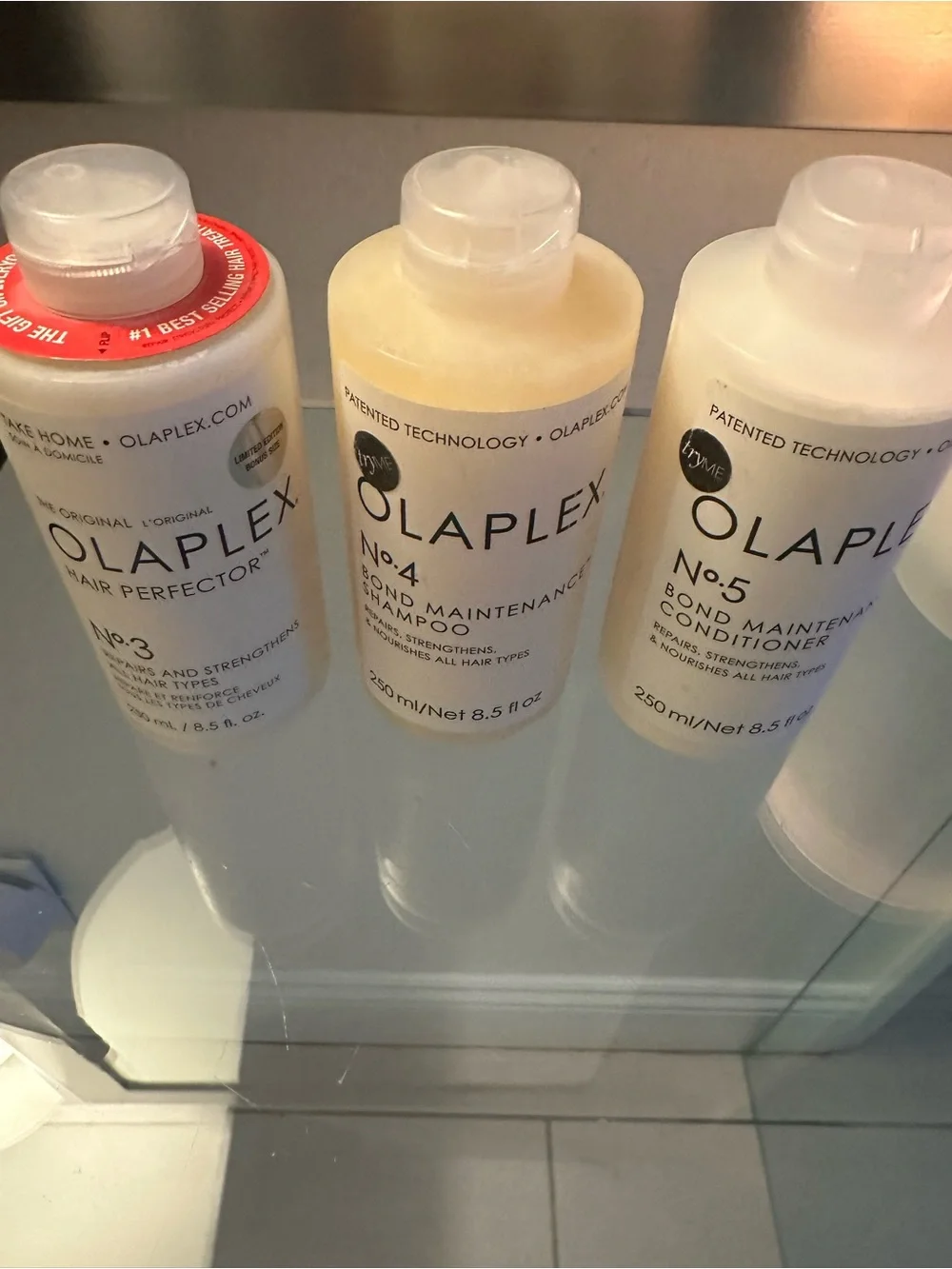 OLAPLEX Trio Hair Care Bottles - White, Cream, Red Accent